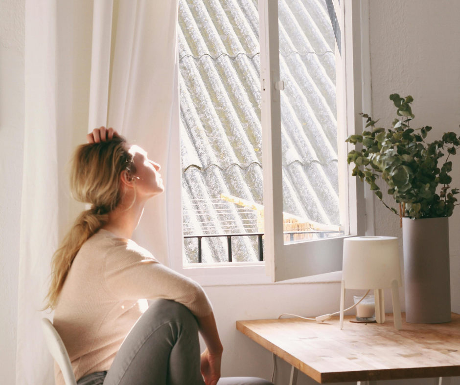 quick self care for moms: woman looking out the window